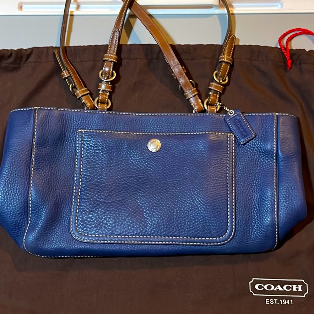 Beautiful navy blue leather Coach handbag, with contrasting brown straps.